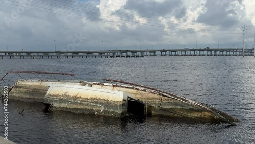 Wrecked boat in the Peace River in 2023 some distance from two (northbound and southbound) concrete bridges along U.S. Route 41 that withstood the landfalls of Hurricanes Ian and Nicole in 2022 photo