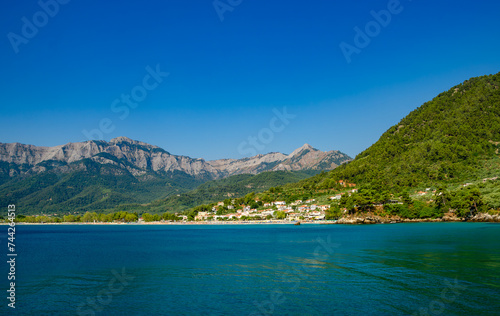 Scenic beach with ocean and distant mountains in Thassos, Greece