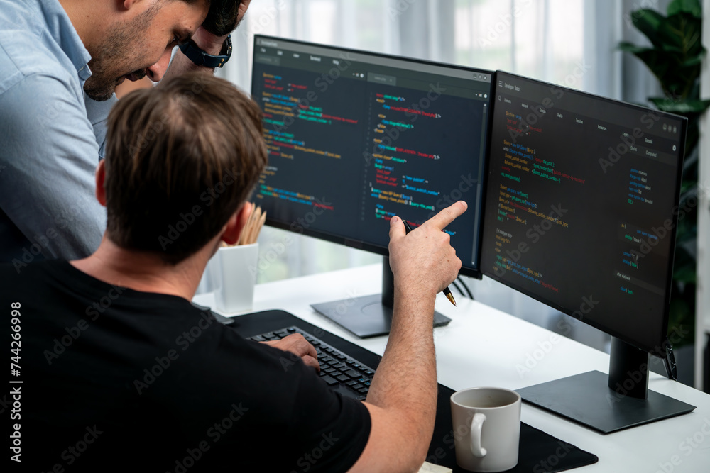 IT developers discussing online software development information on pc screen, creating program coding for latest version application on website. Concept of brainstorming firmware updated. Sellable.