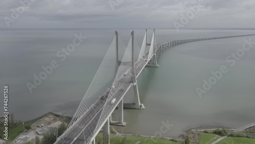 Drone flyover shot of Vasco da Gama bridge over Tagus river in Lisbon Portugal destination photo