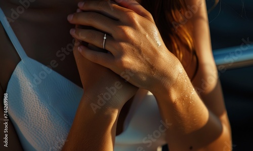 Close-up portrait of woman hands. Hand with ring. Woman in white dress with crossed arms