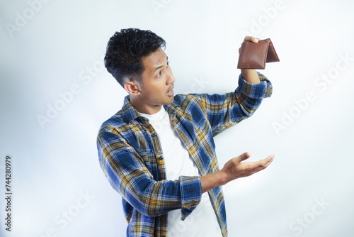 Adult Asian man showing his empty wallet with worried expression