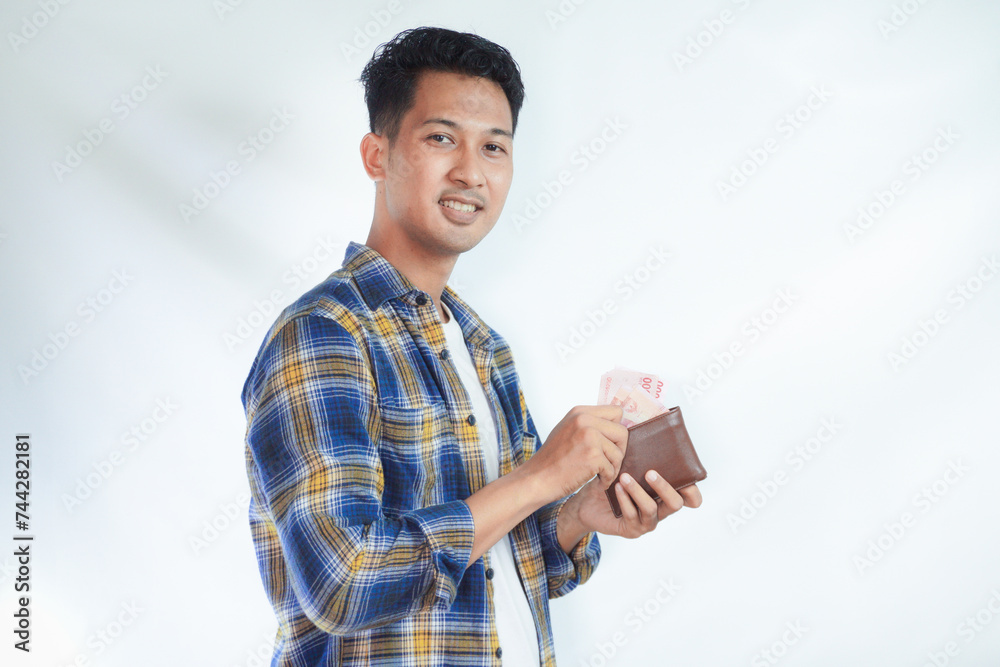 Adult Asian man take paper money from his wallet with happy face