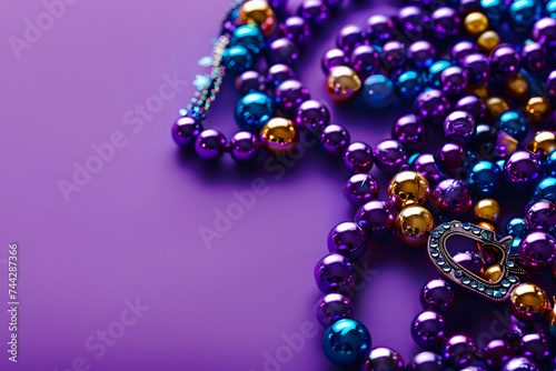Beads on a purple background, suitable for design with copy space, Mardi Gras celebration.