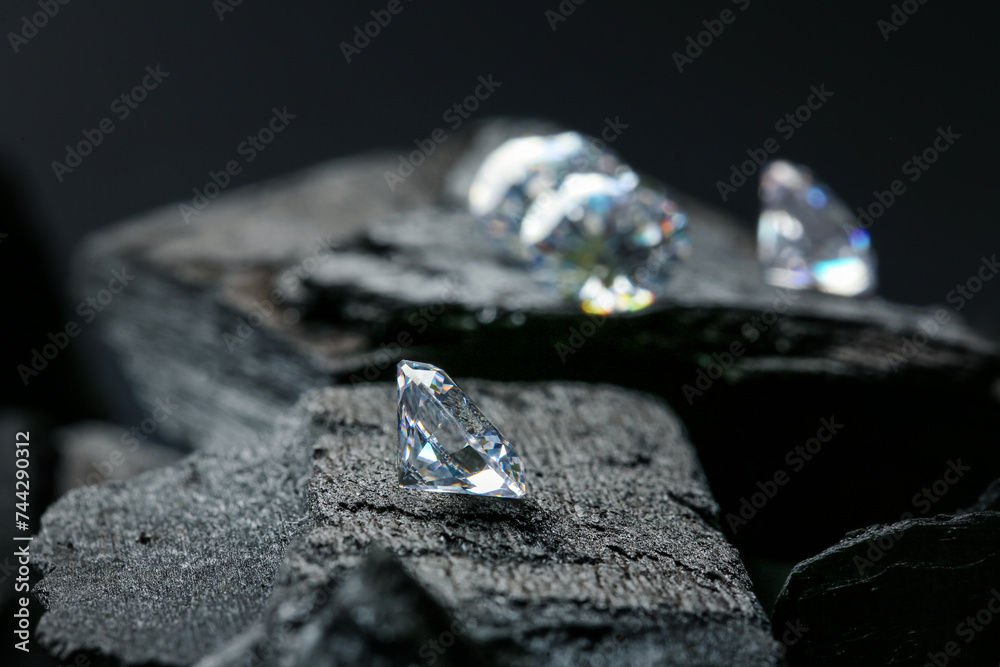 Beautiful shiny diamonds on coals, space for text