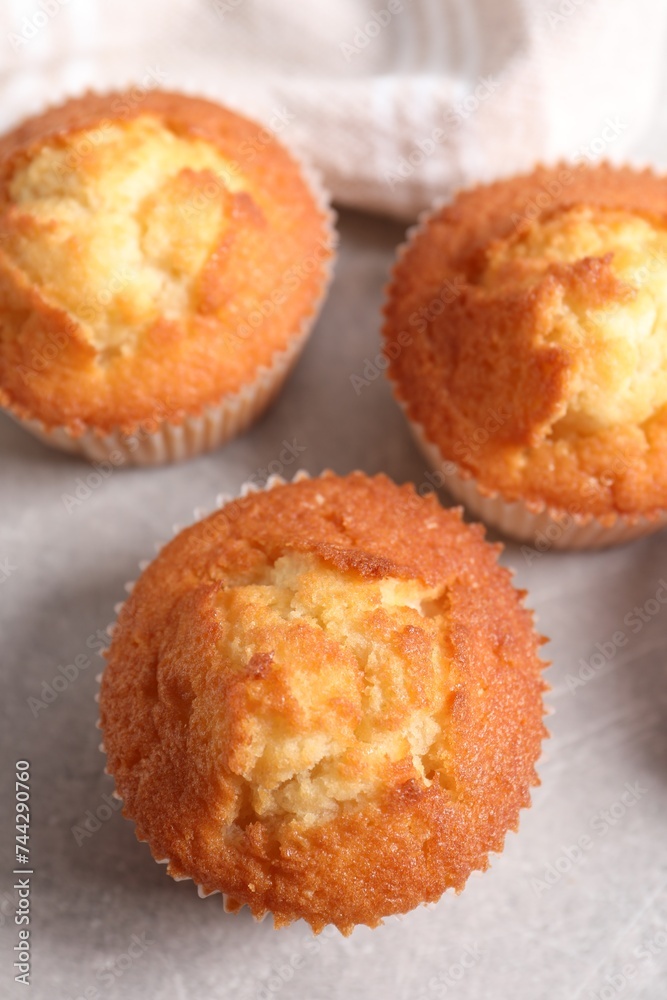 Tasty muffins on light grey table, flat lay. Fresh pastry Tasty muffins on light grey table, flat lay. Fresh pastry