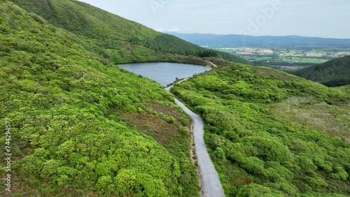 Mountain lake in the middle of green mountains in 4k photo