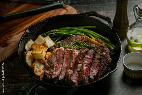 sliced ribeye steak in iron cast skillet pan