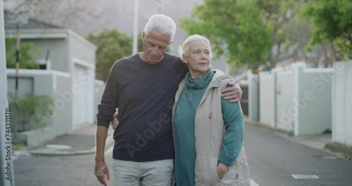 Senior couple on walk in neighborhood together with hug, smile or love in morning conversation. Relax on retirement holiday, old man and happy woman embrace in street for calm, healthy outdoor stroll photo
