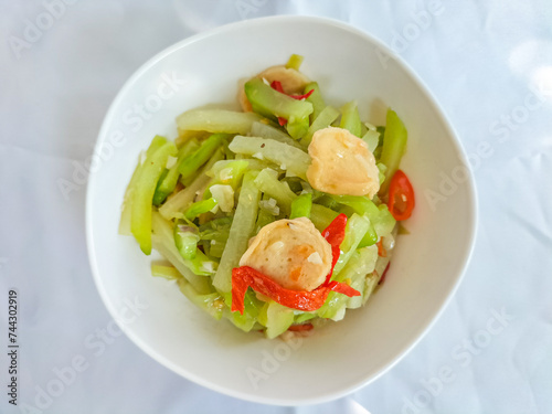 Selective focus. Sayur Labu Siam or Manisa or Jipang or Chayote. Indonesian food. Sayur Godog Labu Siem served in a bowl, isolated on white background. Top view. 