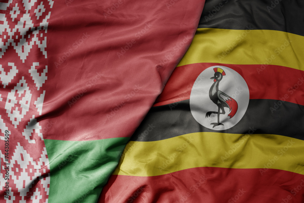 Fototapeta premium big waving national colorful flag of uganda and national flag of belarus.