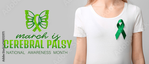 Woman in white t-shirt with green ribbon on grey background. Liver cancer concept