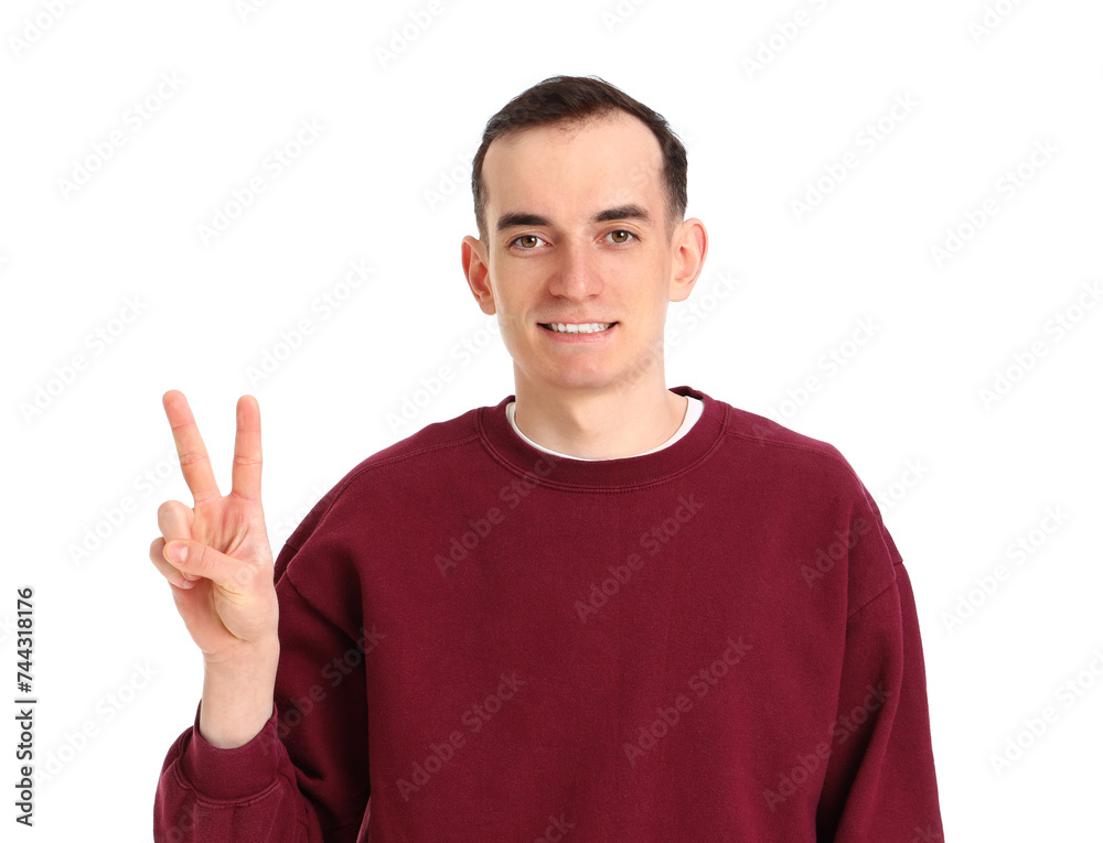 Young man showing two fingers on white background Young man showing two fingers on white background