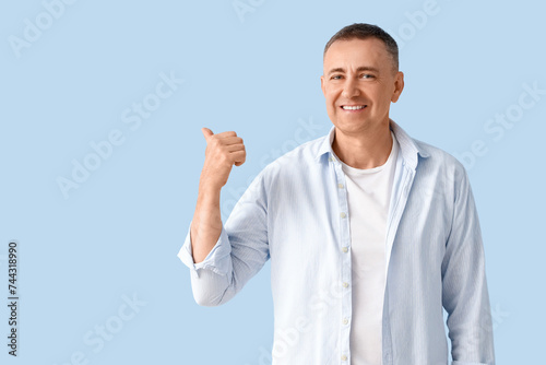 Mature man pointing at some...