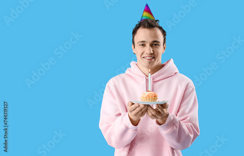 Young man with birthday cak...
