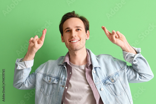 Young man pointing at somet...