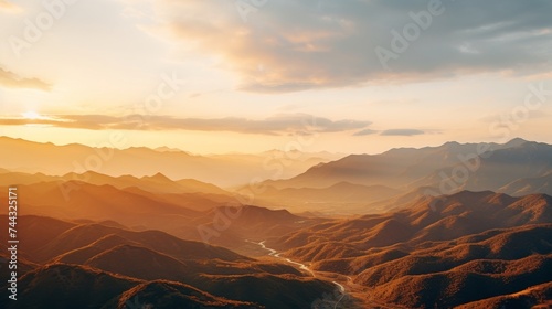 Golden sunlight over a mountain range from a birds eye view