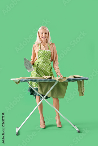Happy mature woman in apron...