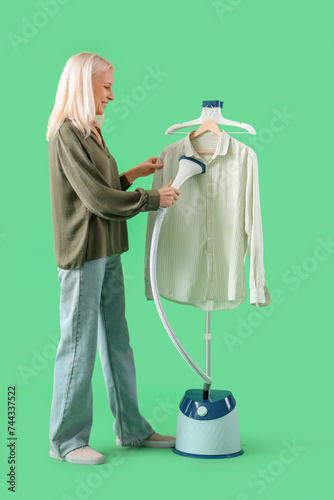 Happy mature woman steaming...