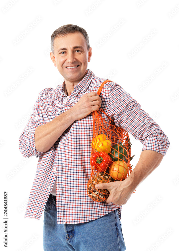 Mature man with string bag of fresh vegetables on white background Mature man with string bag of fresh vegetables on white background