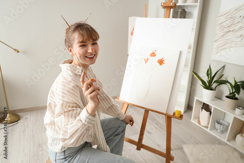 Female artist painting on c...
