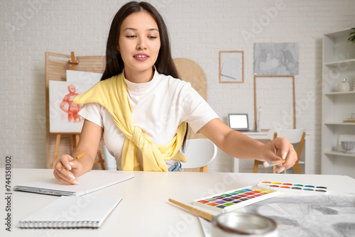 Female Asian artist drawing...