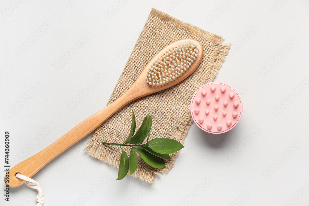 Hair scalp massager and body brush on grey background Hair scalp massager and body brush on grey background