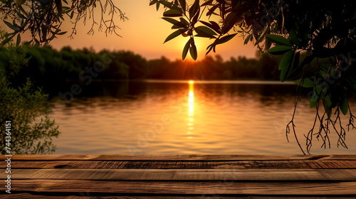 Wooden empty pier overlooking the lake at sunset on a summer evening