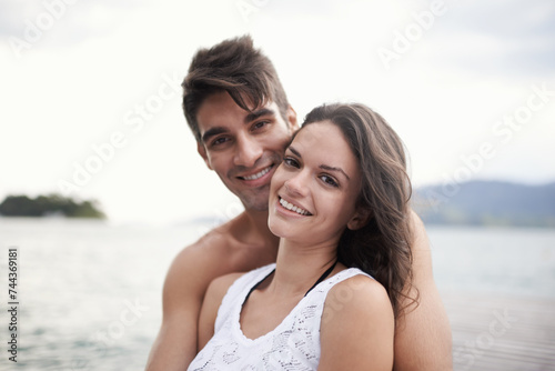 Portrait, smile and couple at sea on vacation, holiday or travel together outdoor in Italy. Face, man and happy woman at ocean for adventure, care and connection in summer by water in nature for love