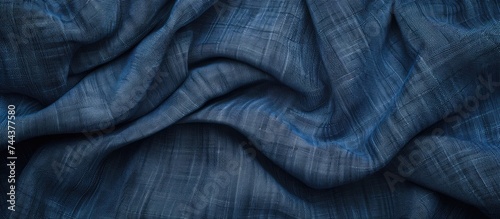 This close-up photo showcases the detailed texture of a blue fabric, specifically denim, against an empty background, making it ideal for wallpaper and design projects.