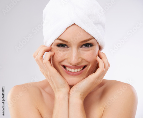 Studio, happy woman and portrait with hair in towel and skincare in spa facial with cosmetology. Young model, smile and face for dermatology with clean shower and body treatment by white background