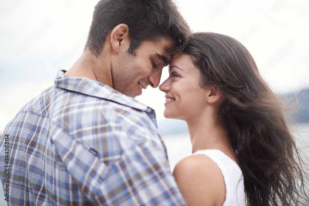 Love, smile and couple at ocean for vacation, holiday or travel together in summer. Happy man, woman and touch face at sea for connection, care and romance on adventure by water outdoor in nature Love, smile and couple at ocean for vacation, holiday or travel together in summer. Happy man, woman and touch face at sea for connection, care and romance on adventure by water outdoor in nature