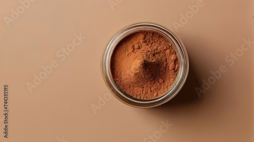 Jar of brown powder on a delicate pastel brown background. Top view. Generated by AI. photo