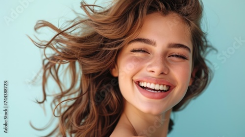 The girl's infectious smile lights up the photo, revealing her dazzling, perfectly-aligned teeth.