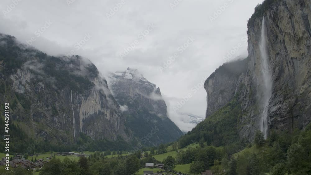 Drone flying through stormy valley in Switzerland