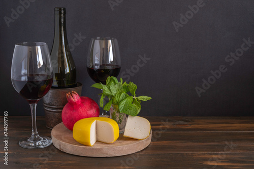 Fresh mint  cheese  pomegranate  red wine on dark wooden background with copy space. Food for Harvest  Shavuot.