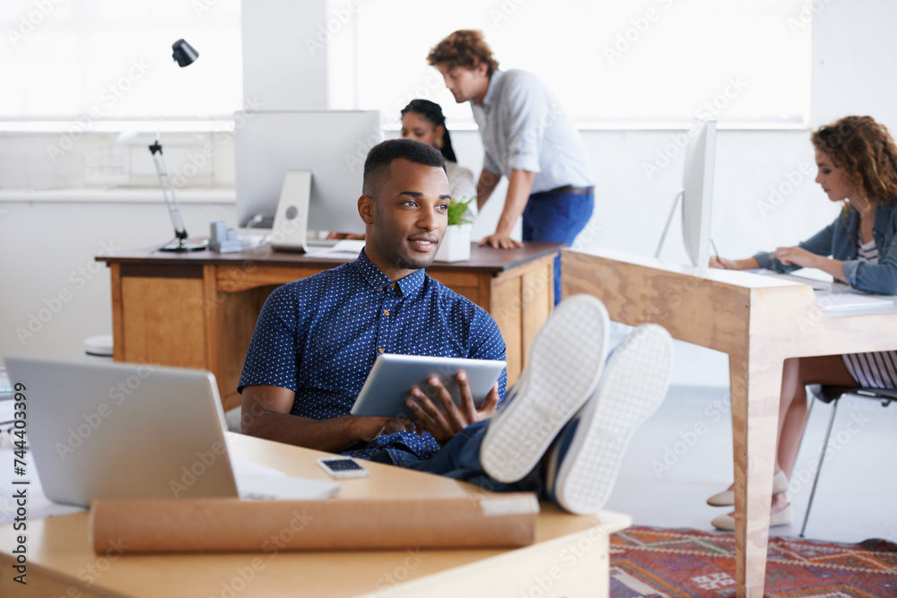 Male, tablet and laptop in office with desk for thinking, research or business. African person and architect with technology, internet or web online for design, innovation and planning in Dublin. Male, tablet and laptop in office with desk for thinking, research or business. African person and architect with technology, internet or web online for design, innovation and planning in Dublin.