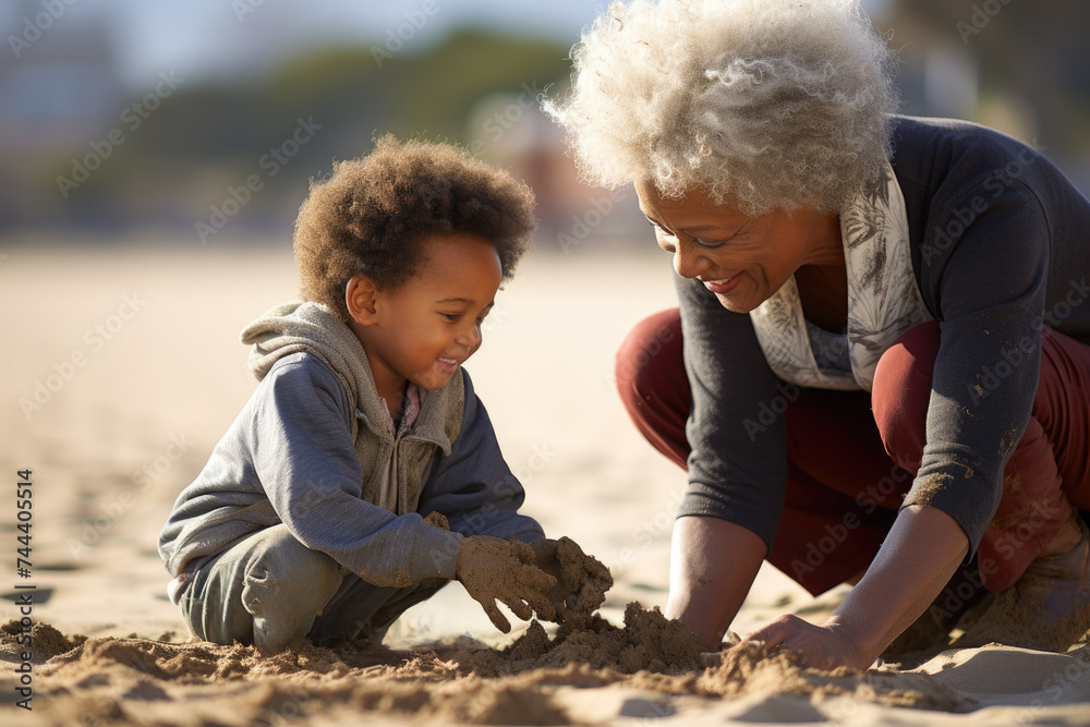Fototapeta premium Joyful Moments Between Grandmother and Grandchild Building Sandcastles on the Beach 