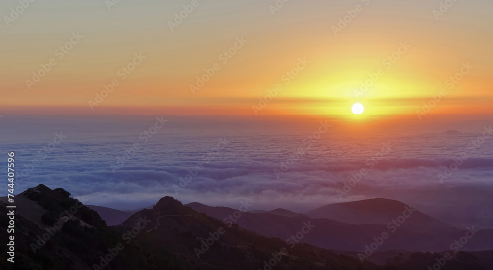 Sun setting above the fog at Fremont Peak State Park. San Benito County and Monterey County, California, USA.