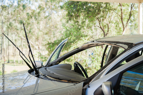 Car with missing windscreen being replaced photo