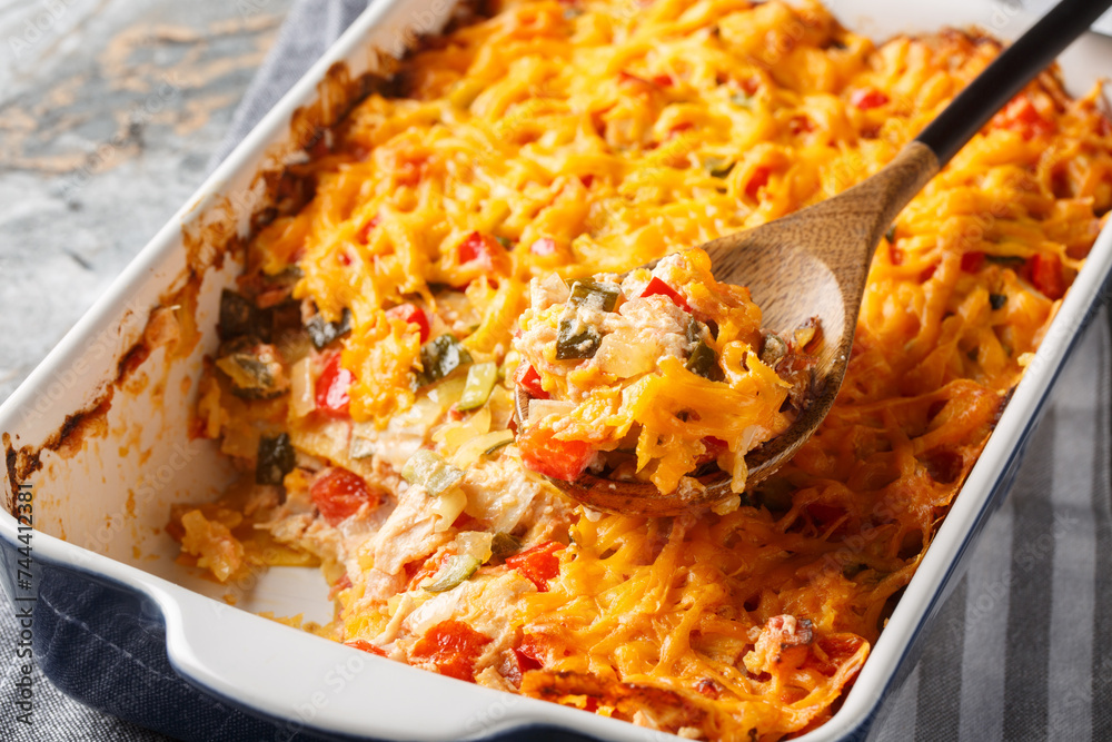 King Ranch Chicken Casserole is a Southern Texas staple dish close-up in a baking dish on a marble table. Horizontal