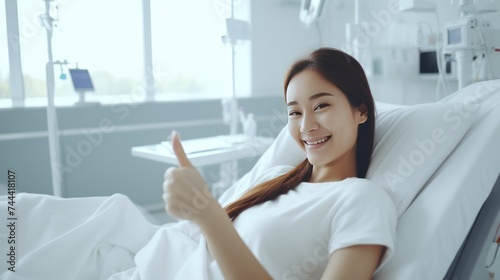 Happy female patient smiling,  and raises thumb up to show 