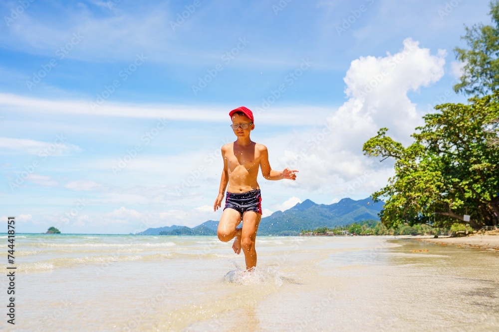 Boy running on the beach Boy running on the beach
