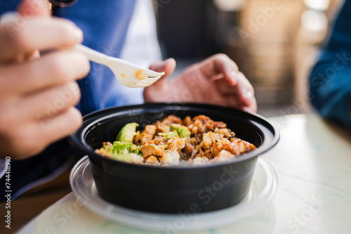 Person eating a takeout meal