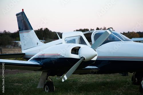 Private twin engine aeroplane on rural landing strip at dusk