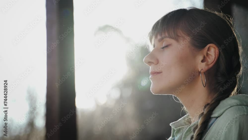 Portrait of a young Caucasian woman meditating and enjoying the fresh air outdoors at sunset. Portrait of a young Caucasian woman meditating and enjoying the fresh air outdoors at sunset.