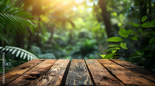 A wooden table in front of a green, leafy jungle background.