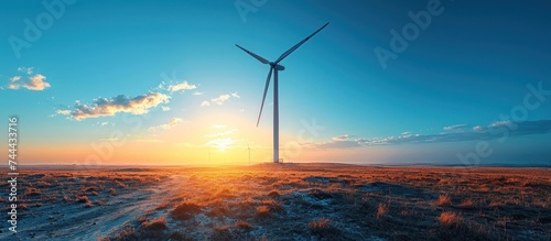 Windmill turbines generate electricity green energy transition against clear blue sky
