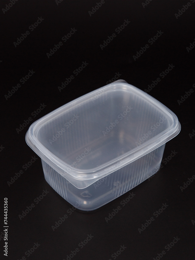 Empty plastic disposable food container, transparent lid isolated on black background. Empty plastic disposable food container, transparent lid isolated on black background.