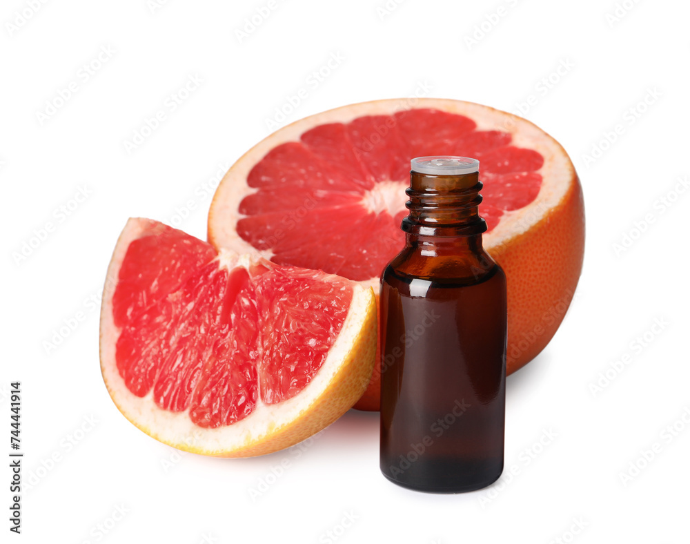 Bottle of grapefruit essential oil and fresh fruit isolated on white Bottle of grapefruit essential oil and fresh fruit isolated on white
